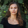 Woman outdoors wearing the gold plated silver Sacred Fusion Star of David necklace. This unique Judaica gift contains the entire Tanakh on a 0.2" nanochip. Ideal for Bat Mitzvahs, weddings, or spiritual milestones.